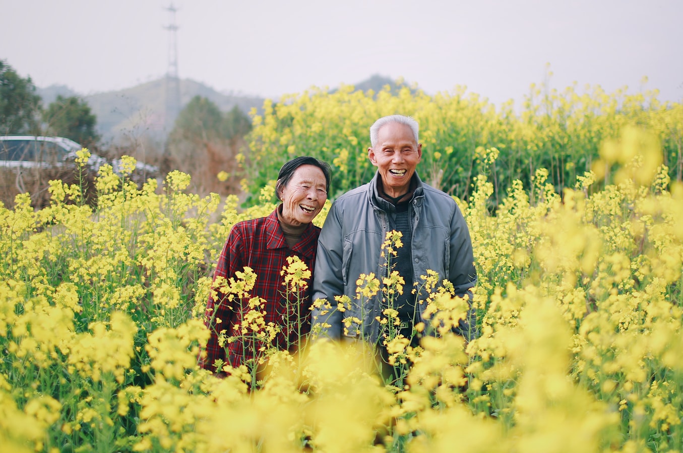 Older couple in a field of wild flowers